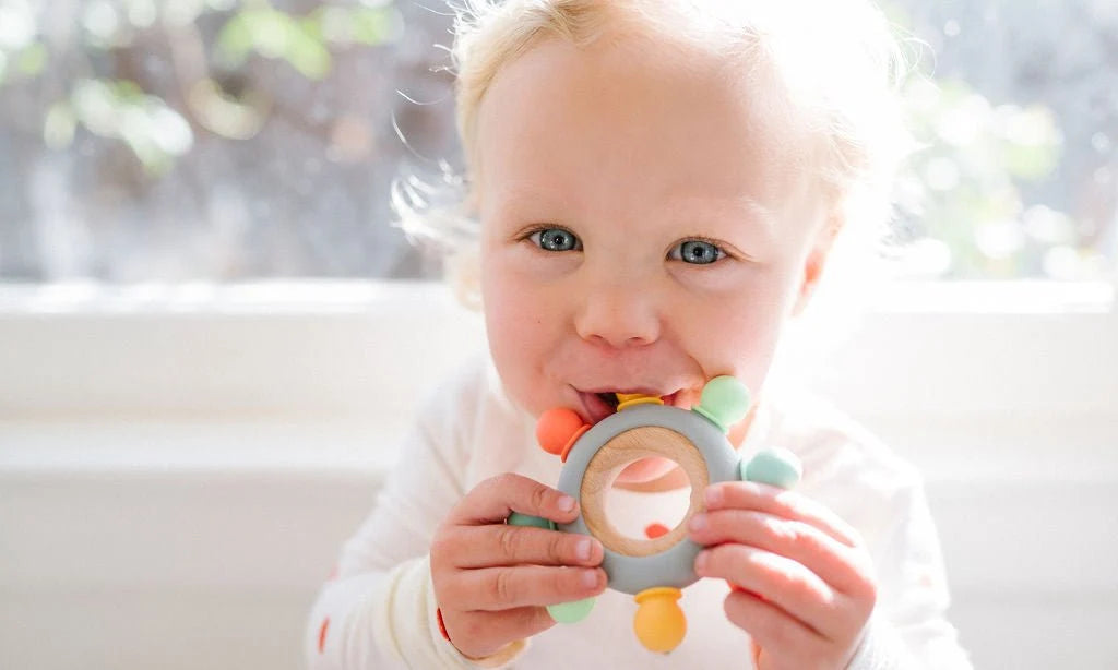 Baby Teether with Eight Silicone Nubs and Beech Wood Ring, Freezer Friendly in Five Color Designs