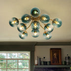 Blue Glass Bubble Semi Flush Chandelier with Gradient Globes and a Curved Brushed Brass Sputnik Frame