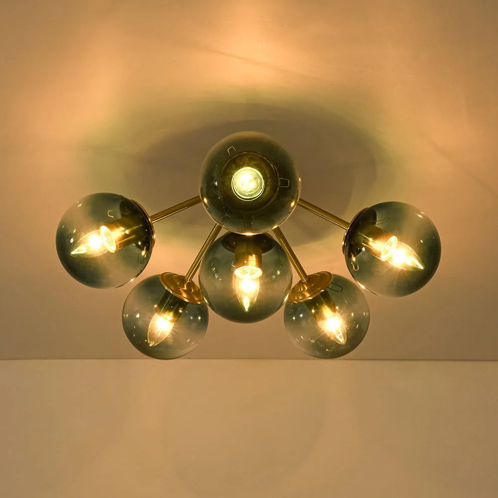 Blue Glass Bubble Semi Flush Chandelier with Gradient Globes and a Curved Brushed Brass Sputnik Frame