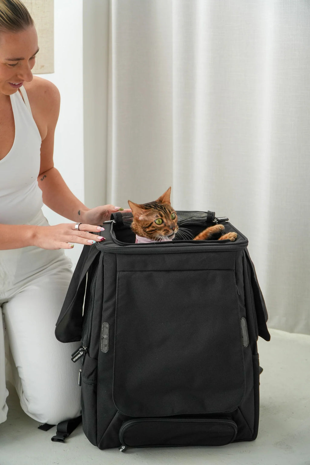 Cat Carrier Backpack with Technical Performance Materials and a Design Centered on Feline Curiosity