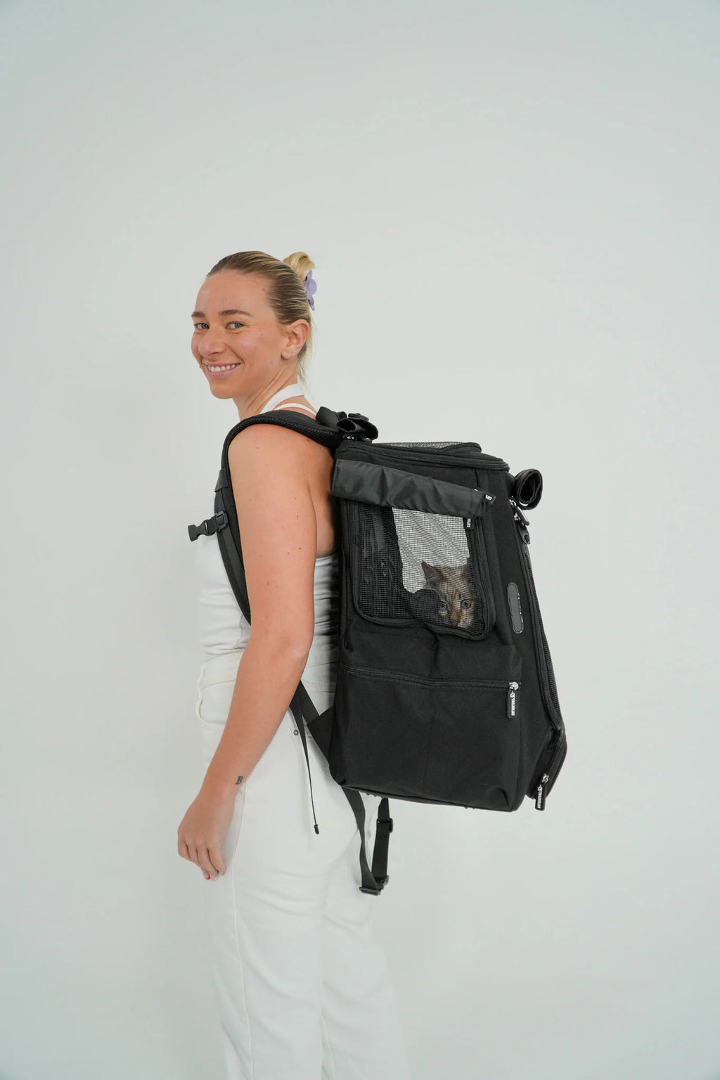 Cat Carrier Backpack with Technical Performance Materials and a Design Centered on Feline Curiosity