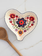 Ceramic Spoon Rest with Heart Detail for a Clean, Cheerful Kitchen Countertop · Helps keep a kitchen countertop clean whil