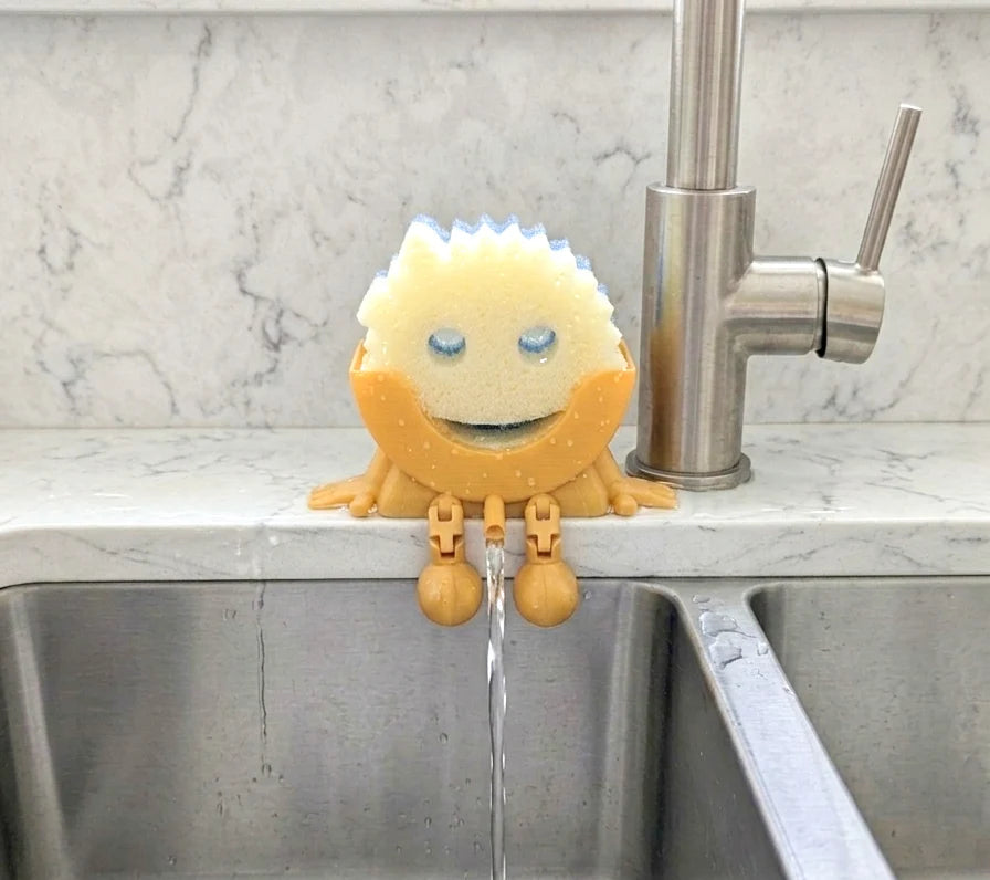 Kitchen Sponge Holder with Articulated Dangling Legs and a Front Drainage Spout for Sink-Side Storage