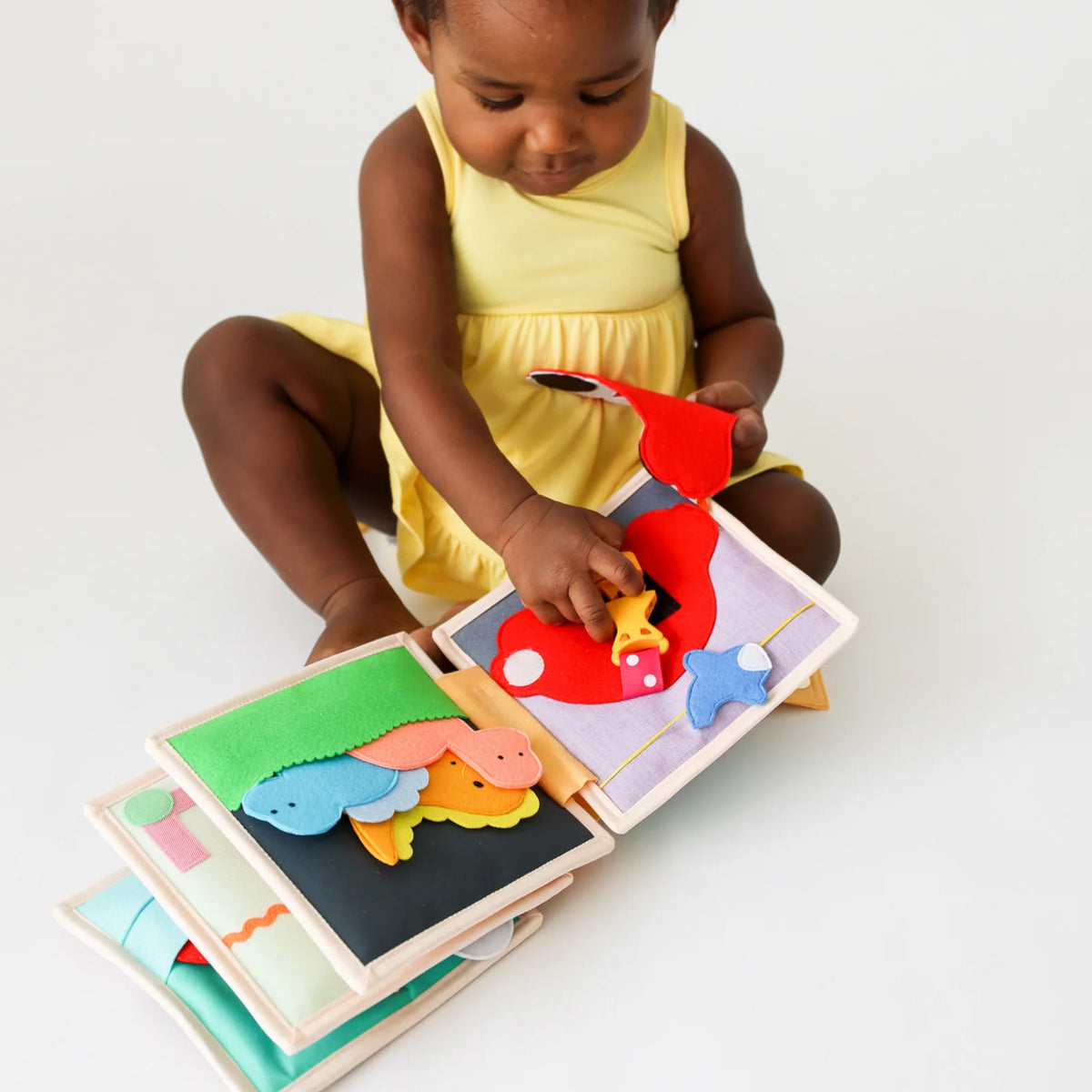Mini Busy Book for Practical Skills and Imaginative Play with Three Dinosaur Finger Puppets