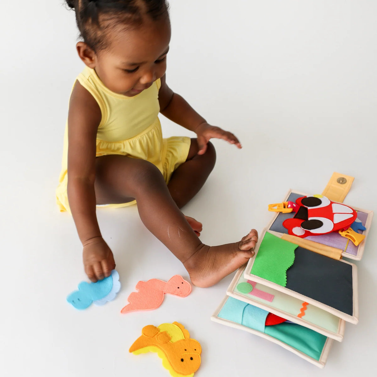 Mini Busy Book for Practical Skills and Imaginative Play with Three Dinosaur Finger Puppets