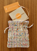 Reusable Drawstring Gift Bag in Multicolored Woven Poly with a Solid Gray Felt Back for Gift Presentation — Multicolor Woven