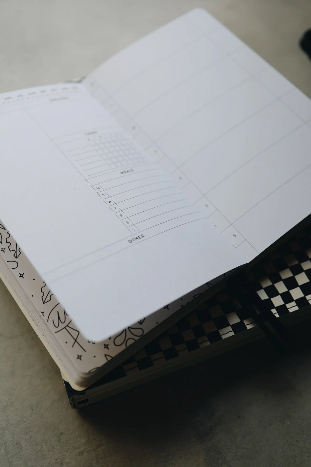 Undated Weekly Planner with a Wipeable Checkers Cover and Equal Space for Weekdays and Weekends