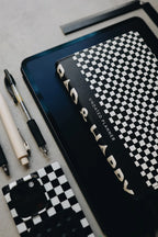 Undated Weekly Planner with a Wipeable Checkers Cover and Equal Space for Weekdays and Weekends