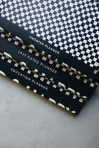 Undated Weekly Planner with a Wipeable Checkers Cover and Equal Space for Weekdays and Weekends